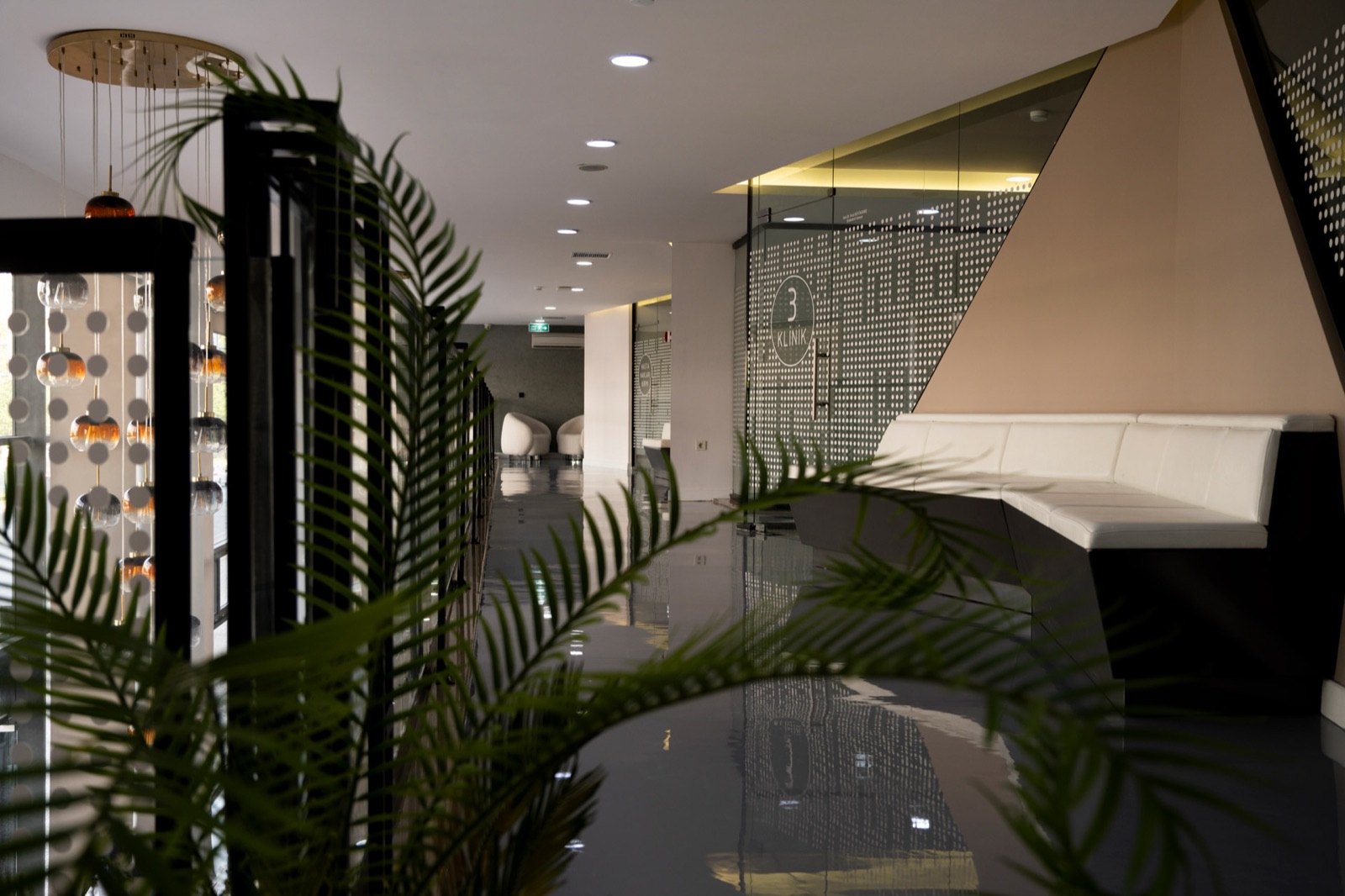 Upper-floor corridor with clinic room signage and a seating nook